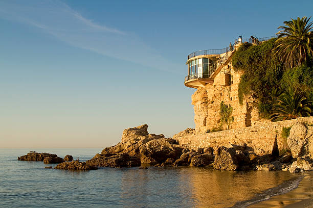 Balcony of Europa at sunrise in Nerja Balcon de Europa, Spanish landmark at sunrise in Nerja on the Costa del Sol low tide stock pictures, royalty-free photos & images