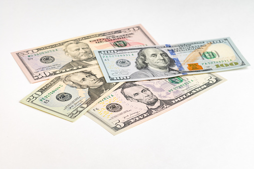 5, 20, 50, 100 dollars banknotes at different angles. Close up of dollars on white background. High quality photo