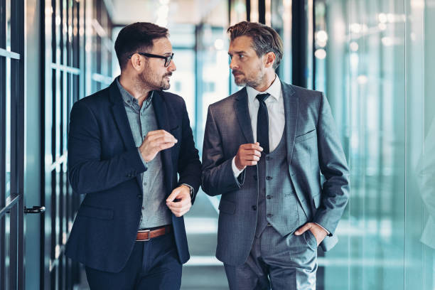 istock Businessmen walking together and talking 1736596538