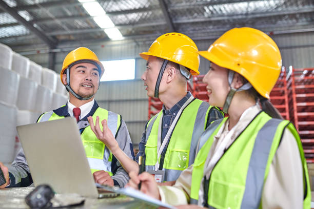 istock Three Asian Worker Using Laptop and Discussion at Cotton Warehouse 1736604692