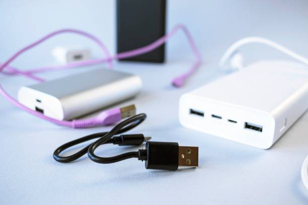 istock Power bank, external battery and usb wire on the table, universal mobile battery for charging gadgets 1736605278