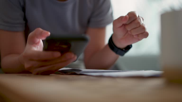 Close-up shot of woman sitting on sofa checking bank papers mortgage debt and cost of living.