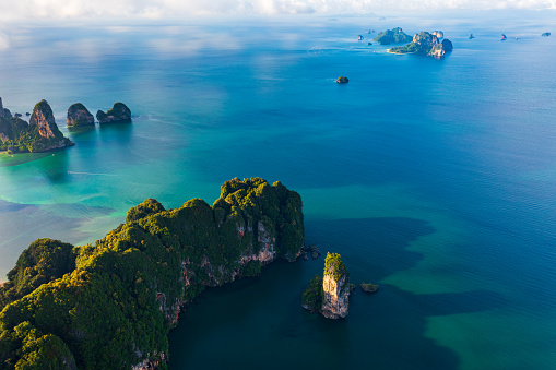 Aerial View over the limestone peaks Looking out at the vast ocean and island at sunrise.  Ao nang, 
Pai Plong, Tonsai, and Railay beach. Krabi, Thailand.