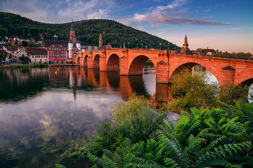 Cityscape image of historical city of Heidelberg, Germany with Old Bridge Gate at autumn sunrise.