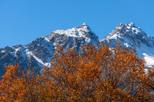 Snow-covered double-headed peak in the Trans-Ili Almaty mountains in the vicinity of Almaty on an autumn morning