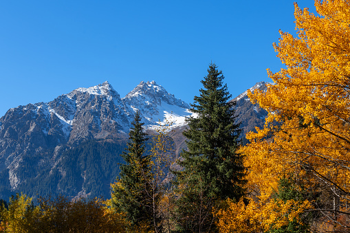 Snow-covered double-headed peak in the Trans-Ili Almaty mountains in the vicinity of Almaty on an autumn morning