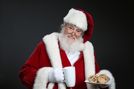 Santa Claus holding milk and cookies