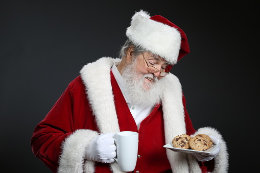 Santa Claus holding milk and cookies