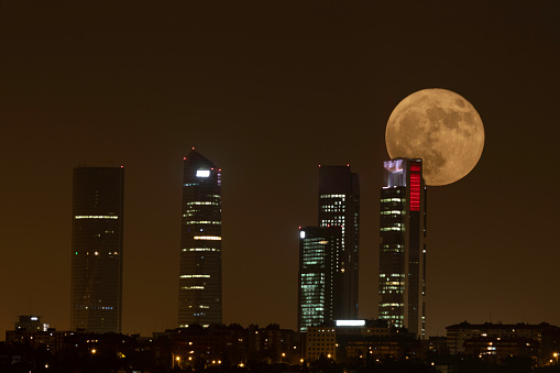 Four Towers business center in Madrid, Spain. Buildings with the full moon above.