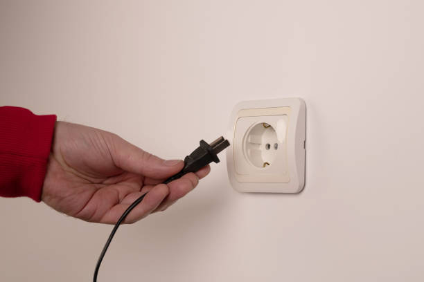 istock Different standards for electrical outlets. Unsuitable connector and plug in the hand of a person. Incompatibility, concept 1736678263