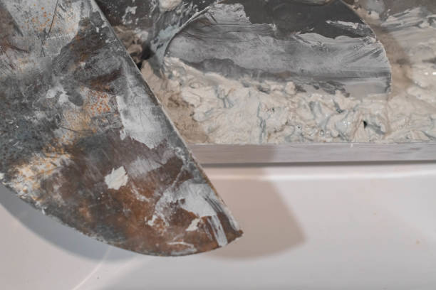 istock Plaster compound knifes in mixing bucket, copy space construction home renovation backgrounds. 1736696026