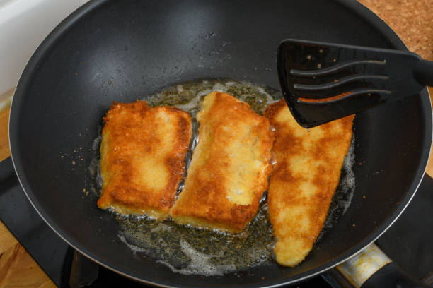 istock fried fish in breadcrumbs in a deep frying pan 1736696614