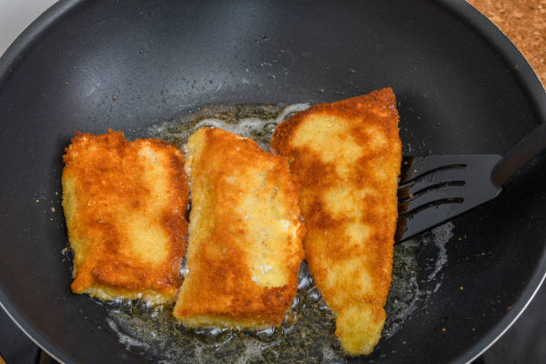 istock Golden pieces of fish deep-fried in a pan 1736698355