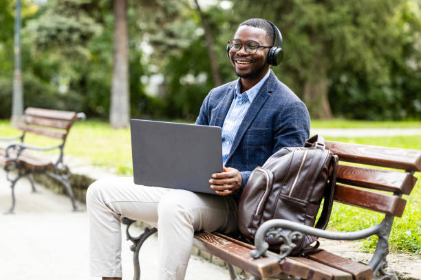 istock Modern businessman enjoying beautiful day at park. 1736710597