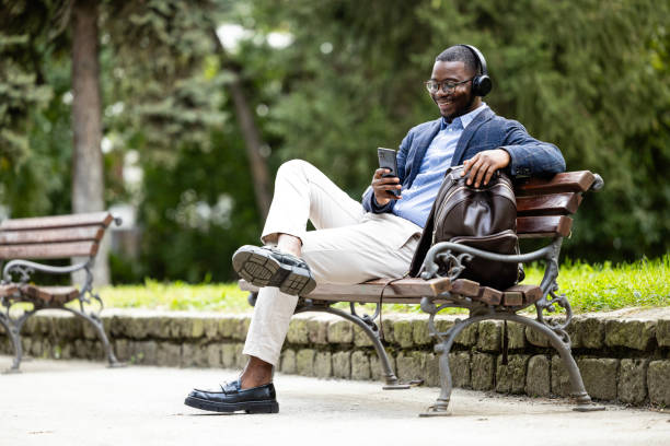 istock Man in business suit relaxing in the park. 1736711121