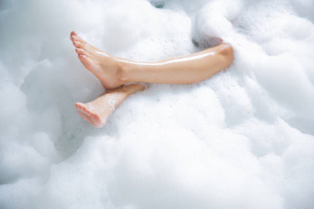 Women's feet she was happily bathing in a bathtub.