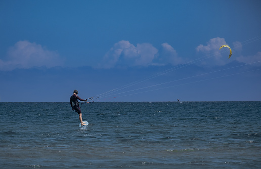 Cabarete, Dominican Republic - February 14, 2009: Kiteboarders enjoying strong wind at popular Cabarete beach on north coast.