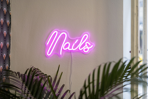 Neon letters in a Nail salon with the words Nails in pink color