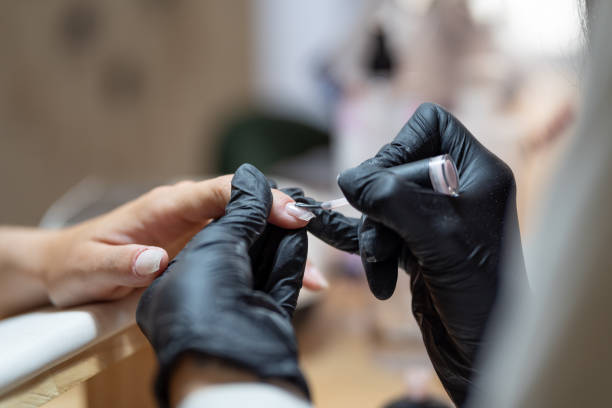 Technician painting the nails of a client