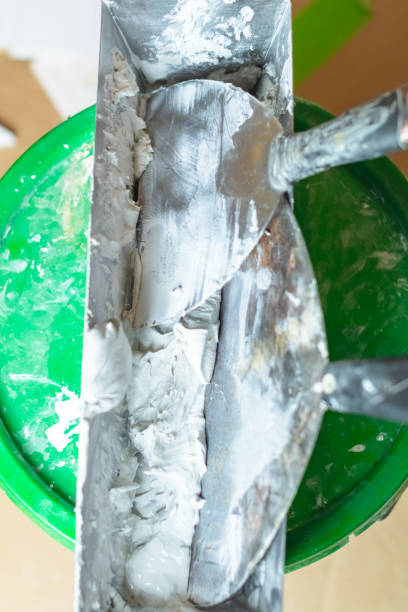 istock Plaster compound knifes in mixing bucket, copy space construction home renovation backgrounds. 1736731929