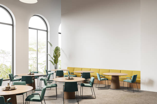 istock Cafe interior with seats and table, sofa near panoramic window. Mock up wall 1736753635