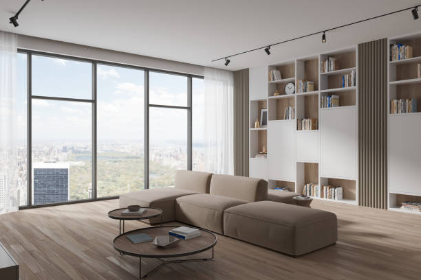 istock Stylish living room interior with couch and shelf with decor, panoramic window 1736754468