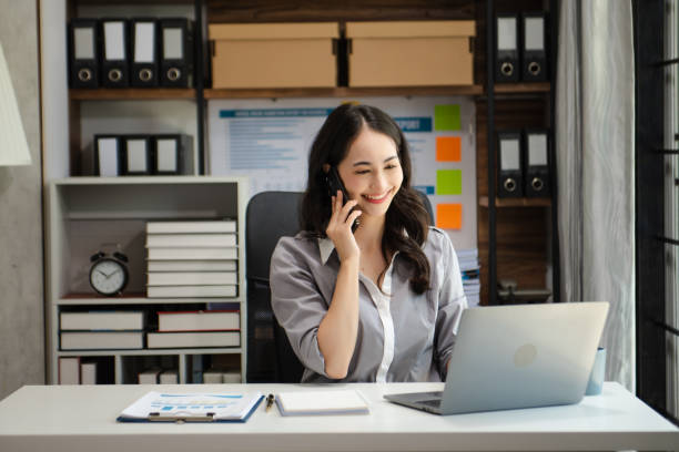 istock Confident beautiful Asian businesswoman typing laptop computer and digital tablet while holding tablete at office 1736764842