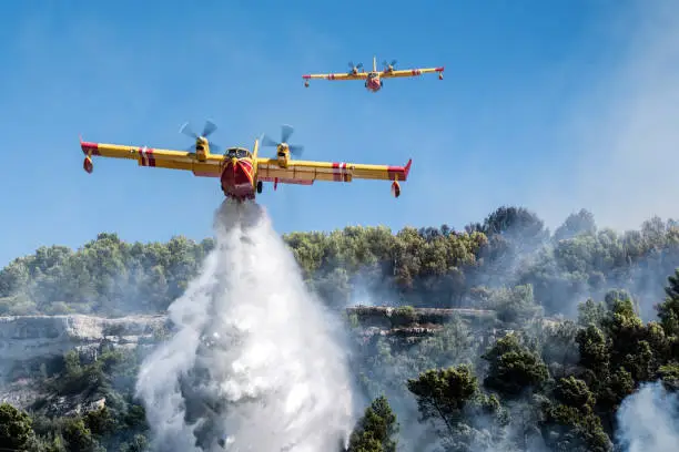Photo of Two Cl415s Canadair dropping water on a fire