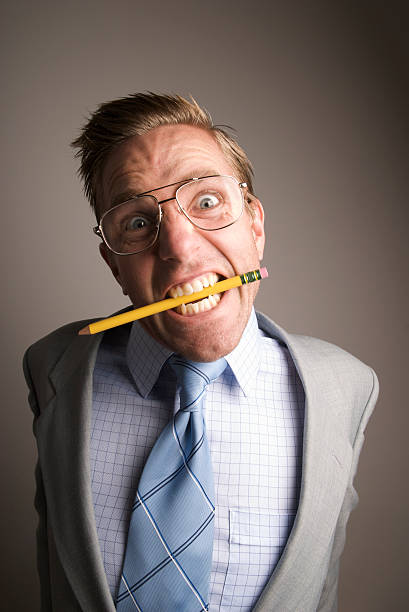 istock Stressed Out Nerdy Guy Chews Pencil 173677719