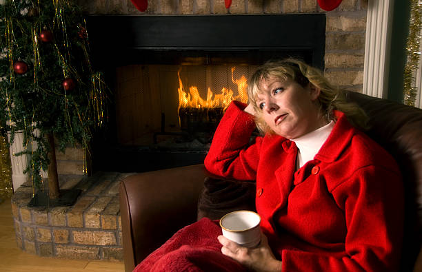 Thoughtful woman by the Fireplace at Christmas