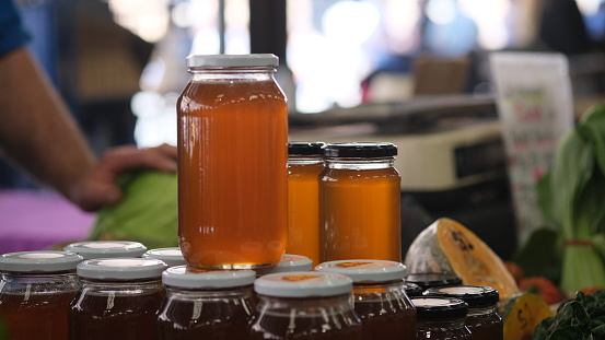 Bee honey in a jar for sale in a farmer market.