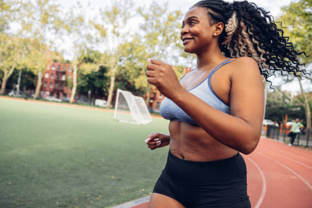 istock Woman running in a running track 1736786926