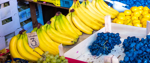 bananas with grapes and plums at the market