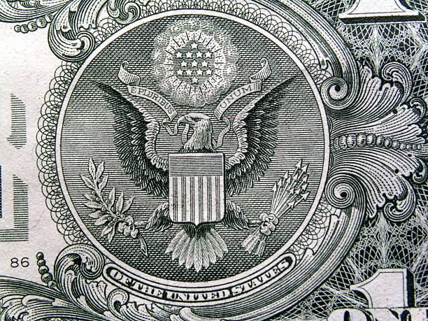 Eagle On US Dollar Bill Closeup of the US dollar bill showing the bald eagle which makes up one side of the Great Seal of the United States. dollar bill eagle stock pictures, royalty-free photos & images