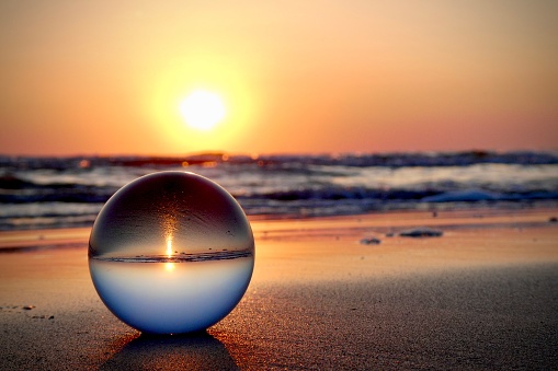 Crystal ball at beach during dawn