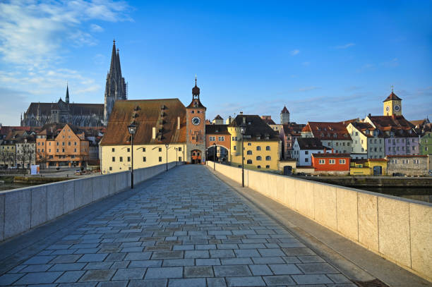 istock Stone bridge and clock tower in Regensburg Germany 1736815899