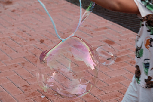 Park of Bateria, Arroyo de la Miel, Málaga, Children playing with soap bubbles