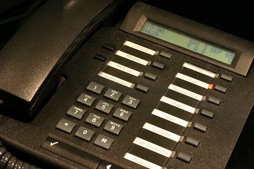 A closer view of an office telephone with many functions.
