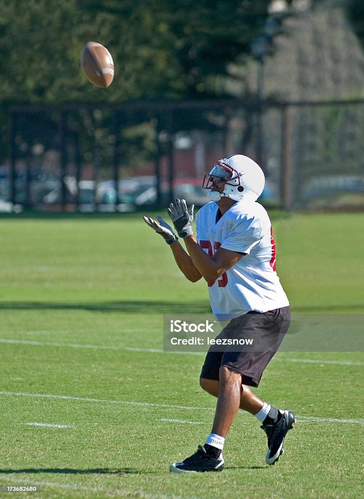 Football Practice Catch A football player catching a punt during practice.Other football shots: American Football Player Stock Photo