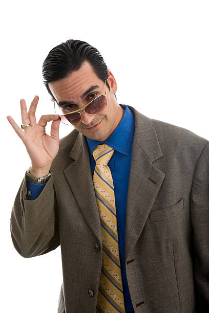 istock Young man wearing suit and glasses looking over glasses 173683178