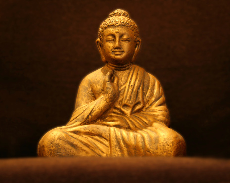 A golden buddha statue sits in peaceful meditation.*Note: Buddha has a clipping path.