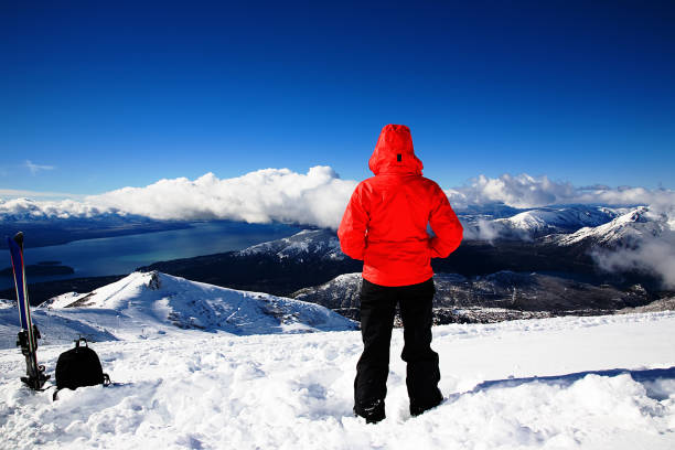Person looking out over the snowy mountains Woman Looking at View in Ski Resort bariloche stock pictures, royalty-free photos & images