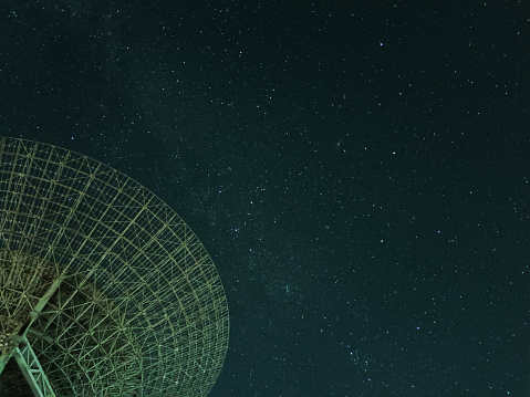Huge white satellite dish under the starry sky