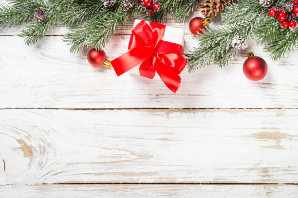 istock Winter fir tree with snow and decorations at white table. 1736855961