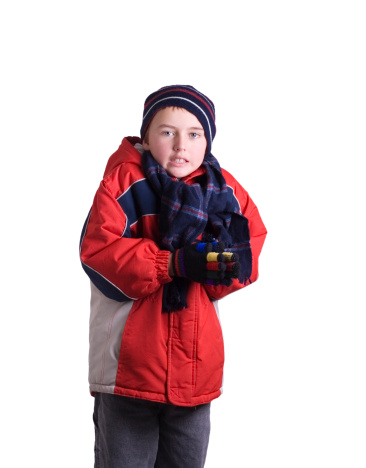 A young boy in a red coat shivers in the cold. Isolated on a white background. Adobe RGB 1998 profile.