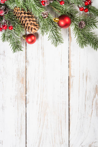 istock Winter fir tree with snow and decorations at white table. 1736859351