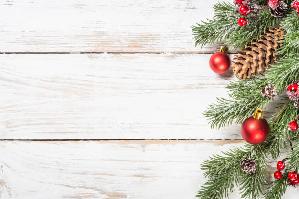 istock Winter fir tree with snow and decorations at white table. 1736859381