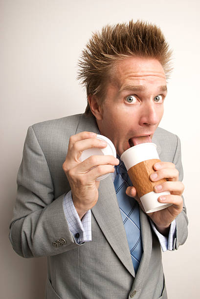 istock Young Man Caffeine Fiend Businessman Drinking Coffee Licking Cup 173686009