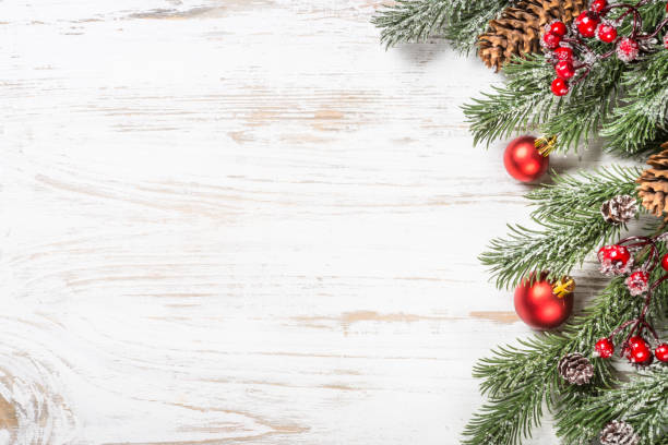 istock Winter fir tree with snow and decorations at white table. 1736860776