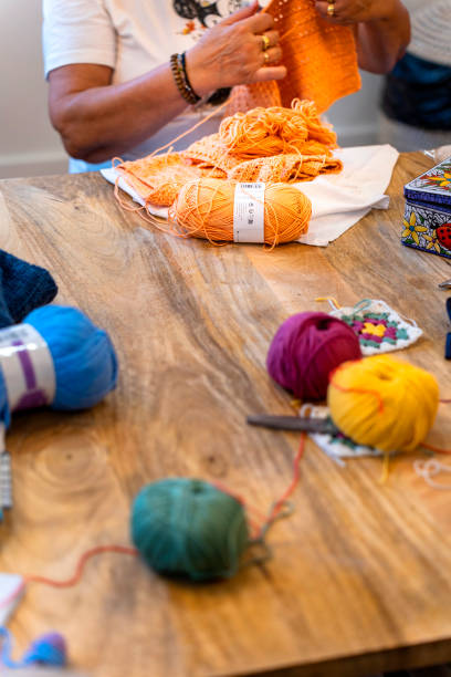 istock Crochet Club. Older lady knitting with colored wool. 1736876664